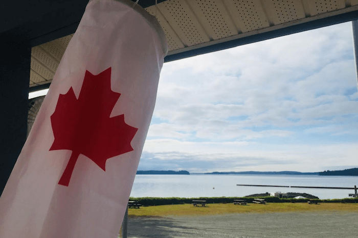 Canadian flag looking out over water